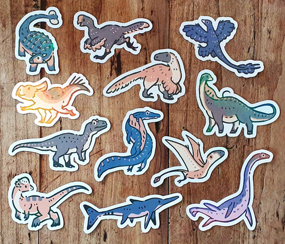 12 autocollants différents représentant des dinosaures et d'autres animaux préhistoriques.